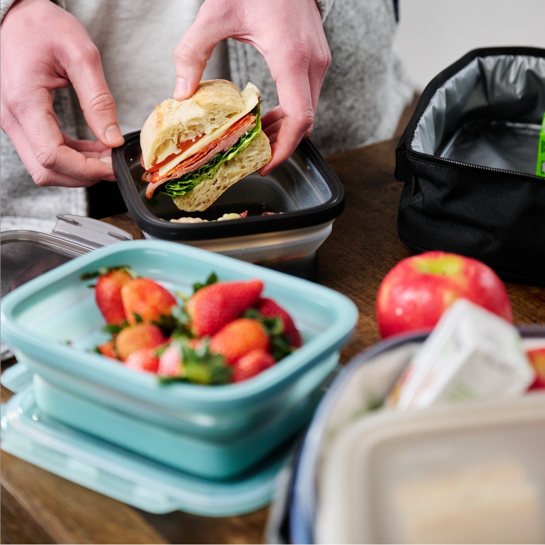 Sandwich being placed in secondz container
