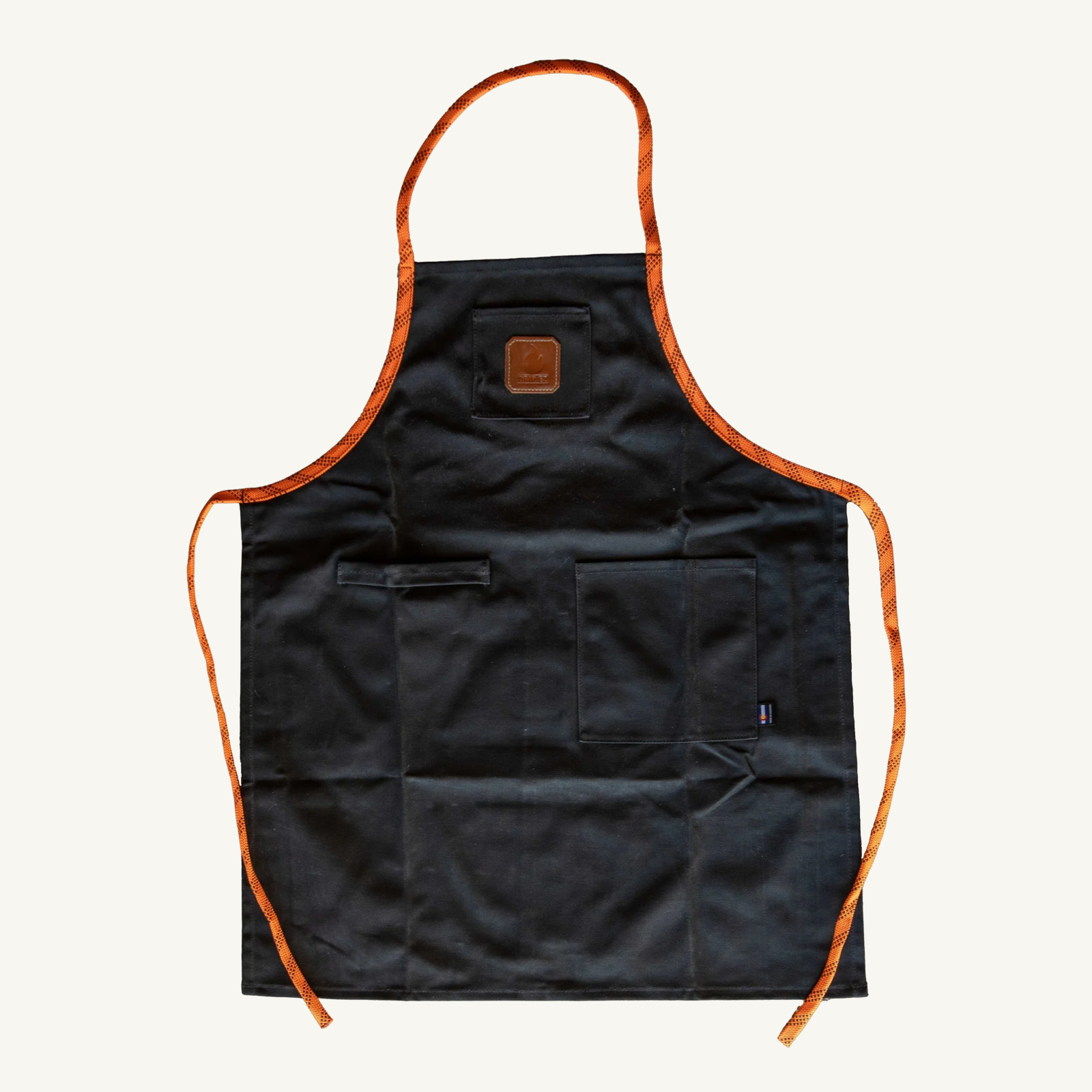 Black apron with orange trim on a white background