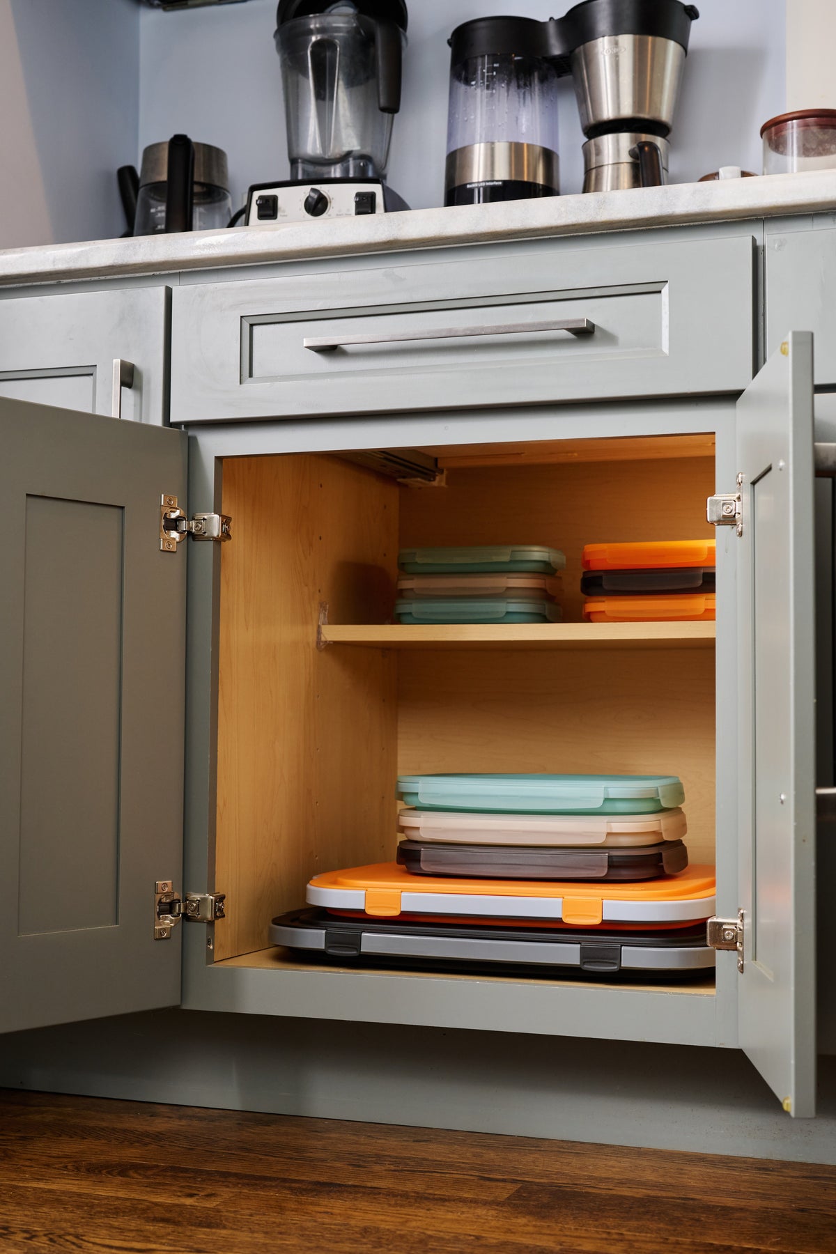After: collapsed containers stacked neatly on kitchen cabinet shelves