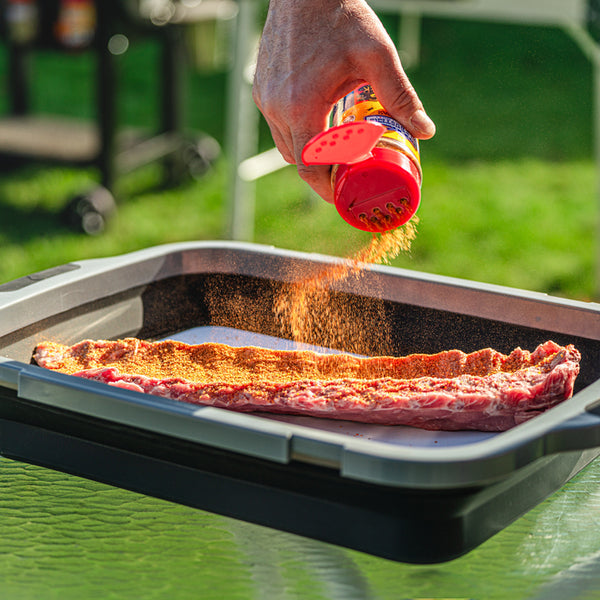 Spicing meat in black prep tub